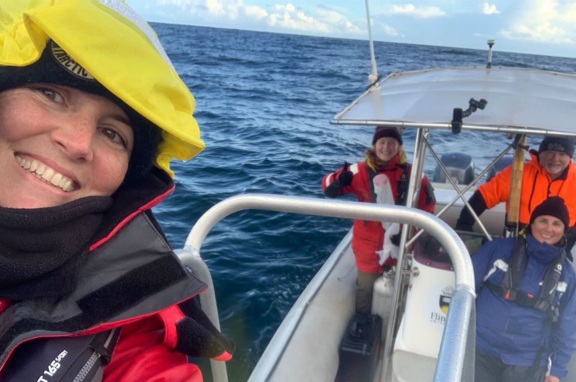 The satellite tagging team after a successful tag deployment. Left to right: Sarah Laverick of Blue Planet Marine, Claire Barr of Flinders University, Rob Slade of Blue Planet Marine and Luciana Möller of Flinders University. Image: Flinders University