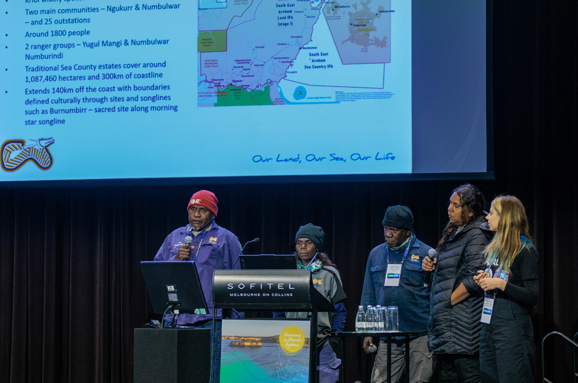 Numbulwar Numburindi rangers Clive Nunggarrgalu, Sarah Nundhirribala, Roger Thompson and Jana Daniels, and Anna Gordon from the Northern Land Council. This presentation outlined cultural Law, and seagrass mapping and protection. Image: Ascent Media