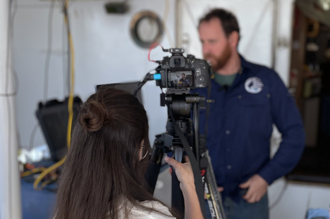 Jessica handles the camera for a live stream during the voyage.