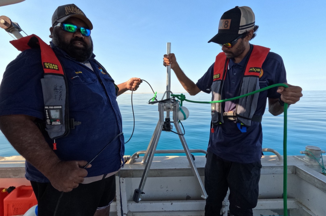 Girringun Rangers Shantaishe Congoo (left) and Doug Bulmer (right) preparing for drone take-off to conduct intertidal seagrass surveys on Girramay Country at Meunga Creek, QLD. Image: Styledia.