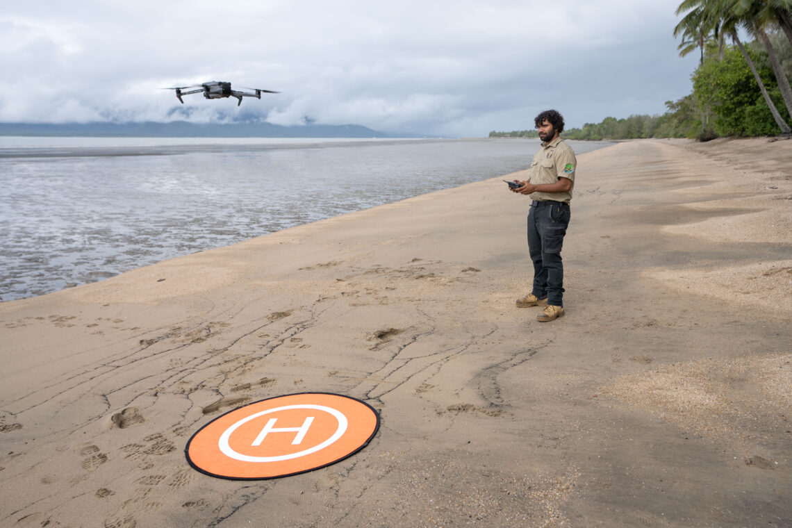 Girringun Ranger, Douglas Bulmer, flying a drone over a seagrass meadow. Image: Styledia